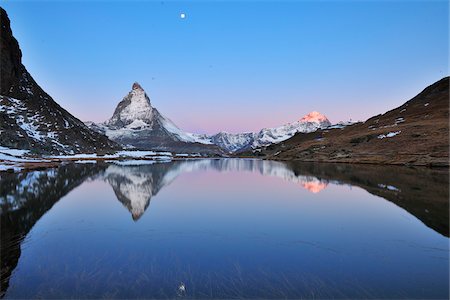 swiss - Matterhorn reflected in Lake Riffelsee at Dawn with Moon, Zermatt, Alps, Valais, Switzerland Stock Photo - Premium Royalty-Free, Code: 600-07278759