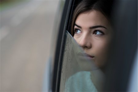 simsearch:600-03787546,k - Portrait of young woman sitting inside car and looking out of window and day dreaming on overcast day, Germany Stock Photo - Premium Royalty-Free, Code: 600-07278925