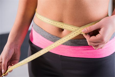 Close-up of Teenager Measuring Waist Photographie de stock - Premium Libres de Droits, Code: 600-07310973