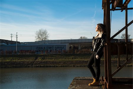 serious city - Teenage girl standing on commercial dock outdoors, looking into the distance, Germany Stock Photo - Premium Royalty-Free, Code: 600-07310996