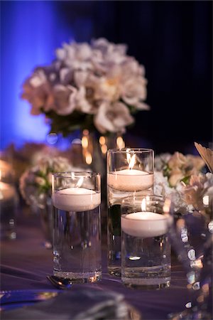 simsearch:700-03587116,k - Close-up of floating candles in glass candle holders on table at reception, with flower arrangements in background, Canada Stock Photo - Premium Royalty-Free, Code: 600-07311010