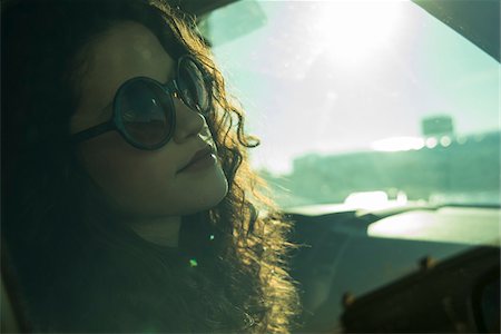 reflections - Close-up portrait of teenage girl sitting in car, wearing sunglasses, Germany Stock Photo - Premium Royalty-Free, Code: 600-07311089