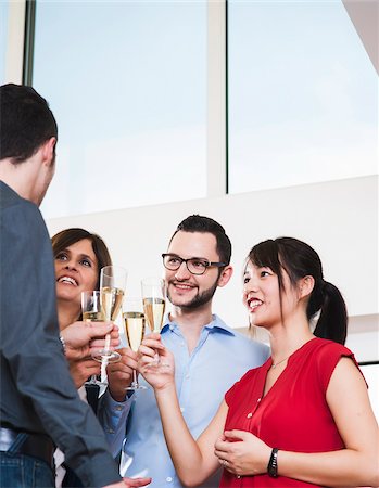 simsearch:600-07311402,k - Mature businesswoman toasting group of young business people with glasses of champagne, Germany Foto de stock - Sin royalties Premium, Código: 600-07311406