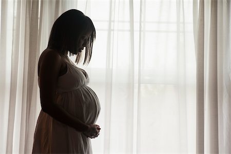 silhouette (darkened or blurred object or figure) - Silhouette of Pregnant Woman Standing by Window Stock Photo - Premium Royalty-Free, Code: 600-07311585