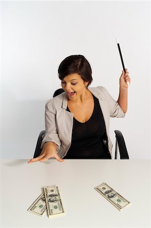 Mid-Adult Woman doing Magic with Magic Wand and $100 Bills Stock Photo - Premium Royalty-Free, Code: 600-07355321