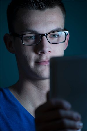 Young Man looking at Tablet Computer, Studio Shot Stock Photo - Premium Royalty-Free, Code: 600-07431248