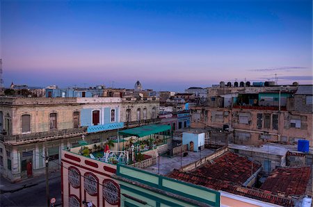 Overview of rooftops of buildings at dusk, Cienfuegos, Cuba, West Indies, Caribbean Stock Photo - Premium Royalty-Free, Code: 600-07451009