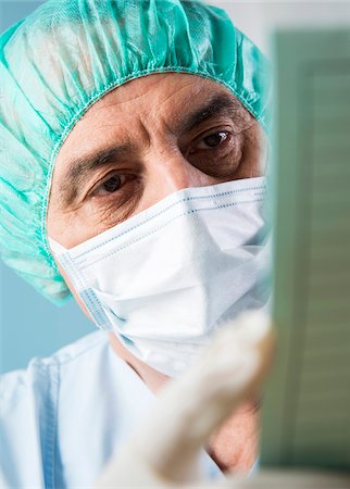 Close-up of Surgeon looking at Medical Chart Stock Photo - Premium Royalty-Free, Code: 600-07487613