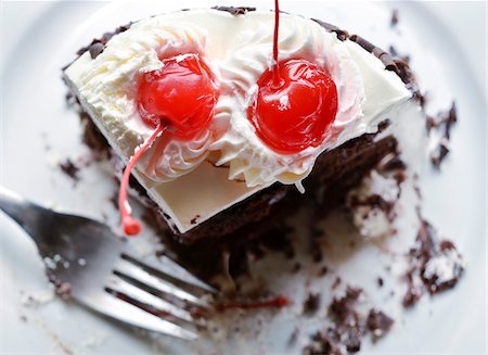 stone fruit - Close-up of black forest cake on plate with fork, studio shot Stock Photo - Premium Royalty-Free, Code: 600-07529001