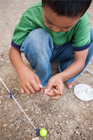 simsearch:600-07529193,k - Crouching Boy preparing Worm for Fishing, Lake Fairfax, Reston, Virginia, USA Stock Photo - Premium Royalty-Free, Code: 600-07529197