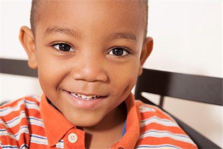 Close-up portrait of African-American boy, smiling and looking at camera, USA Stock Photo - Premium Royalty-Free, Code: 600-07540308