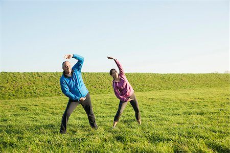 sports outdoor autumn - Adult couple exercising in field, Germany Stock Photo - Premium Royalty-Free, Code: 600-07584748