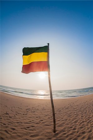 southern province - German Flag on Wooden Stick in Sand at Beach against Blue Sky, Indian Ocean, Bentota, Galle District, Southern Province, Sri Lanka Stock Photo - Premium Royalty-Free, Code: 600-07591311