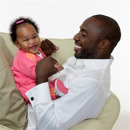 Portrait of Father and Baby Girl on Chair, Studio Shot Stock Photo - Premium Royalty-Free, Code: 600-07784456