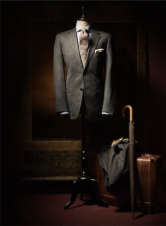 fashion elegant - Suit jacket, shirt and tie displayed on dress form with suitcase, coat, gloves and an umbrella beside on floor, studio shot Stock Photo - Premium Royalty-Free, Code: 600-07783900