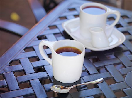 Two White Mugs of Tea on Patio Table with Milk and Spoon, Dundas, Ontario, Canada Stock Photo - Premium Royalty-Free, Code: 600-07802970