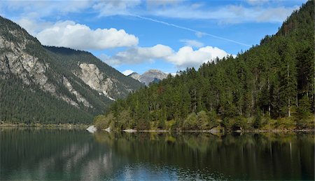 Scenic view of mountains and a clear lake (Plansee) in autumn, Tirol, Austria Stock Photo - Premium Royalty-Free, Code: 600-07911251