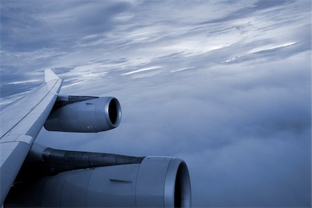 Close-up of the wing and engines of a jet while flying in the clouds Stock Photo - Premium Royalty-Free, Code: 600-07945139