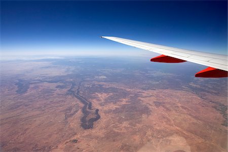 red - Close-up view an airplane wing from the window of a jet while flying over the Arizona desert, USA Stock Photo - Premium Royalty-Free, Code: 600-07945142