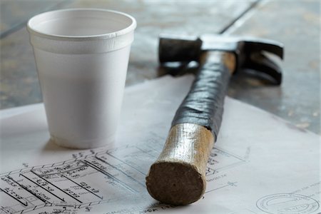 Close-up of hammer, blueprint and styrofoam coffee cup at home improvement project, Canada Stock Photo - Premium Royalty-Free, Code: 600-07965943