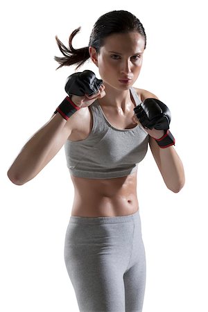 portrait of woman wearing boxing gloves - Portrait of Young Woman wearing Boxing Gloves, Studio Shot Stock Photo - Premium Royalty-Free, Code: 600-07968176