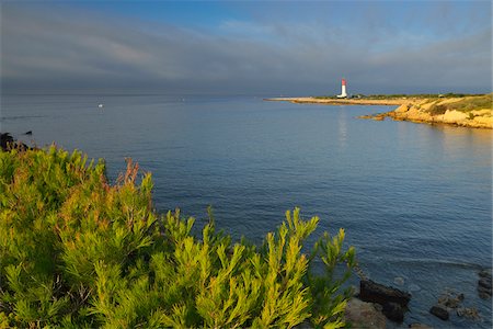 Coast at Morning with Lighthouse, Anse de la Beaunderie, La Couronne, Martigues, Cote Bleue, Mediterranean Sea, Bouches-du-Rhone, Provence-Alpes-Cote d'Azur, France Stock Photo - Premium Royalty-Free, Code: 600-07991524