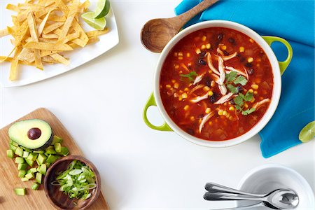 soup top view - Pot filled with chicken, tortilla, black bean soup with ingredients on the side, studio shot Stock Photo - Premium Royalty-Free, Code: 600-08002092