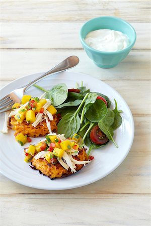 simsearch:600-07067594,k - Sweet potato pancakes on a plate topped with shredded chicken and mango salsa with side salad and dip, studio shot Stock Photo - Premium Royalty-Free, Code: 600-08002127