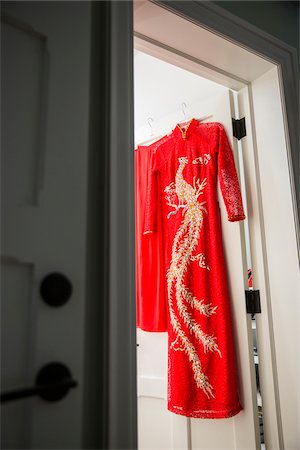 silk dress - Red, cheongsam dress hanging on door at entrance to a room, Canada Stock Photo - Premium Royalty-Free, Code: 600-08002544