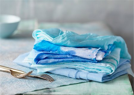 soft pastel - Stack of linens with cutlery on table, studio shot Stock Photo - Premium Royalty-Free, Code: 600-08002551