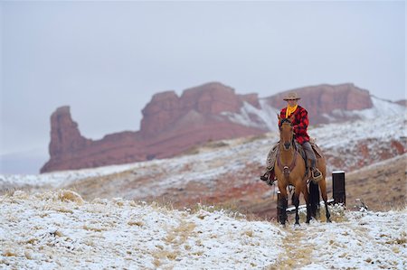 Cowboy Riding Horse in Snow, Rocky Mountains, Wyoming, USA Stock Photo - Premium Royalty-Free, Code: 600-08026181