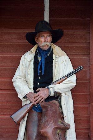 simsearch:400-04308263,k - Portrait of Cowboy with Rifle, Shell, Wyoming, USA Stock Photo - Premium Royalty-Free, Code: 600-08082899