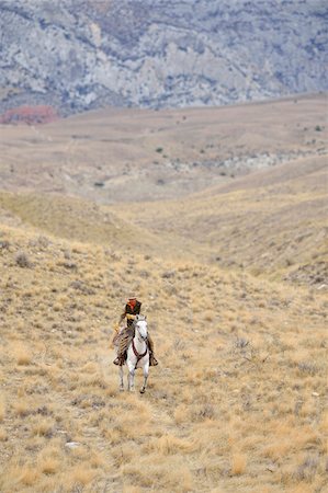 simsearch:700-08416835,k - Cowboy riding horse in wilderness, Rocky Mountains, Wyoming, USA Stock Photo - Premium Royalty-Free, Code: 600-08171769