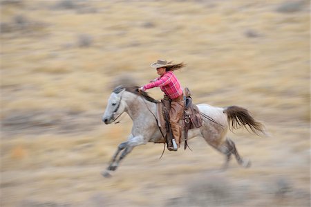 simsearch:400-04529076,k - Blurred motion of cowgirl on horse galloping in wilderness, Rocky Mountains, Wyoming, USA Stock Photo - Premium Royalty-Free, Code: 600-08171776