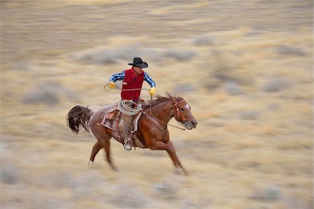 Blurred motion of cowboy on horse galloping in wilderness, Rocky Mountains, Wyoming, USA Stock Photo - Premium Royalty-Free, Code: 600-08171778