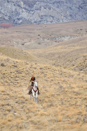 simsearch:400-03955794,k - Cowboy riding horse in wilderness, Rocky Mountains, Wyoming, USA Stock Photo - Premium Royalty-Free, Code: 600-08171770