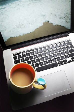 Coffee Mug on Laptop Computer with Beach on Screen Stock Photo - Premium Royalty-Free, Code: 600-08232320