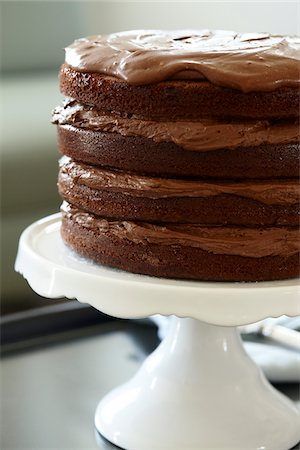 simsearch:600-08274204,k - Layered Chocolate Birthday Cake on Cake Stand Stock Photo - Premium Royalty-Free, Code: 600-08274201