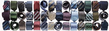 Assortment of ties rolled-up on white background in studio Stock Photo - Premium Royalty-Free, Code: 600-08312068
