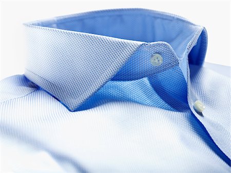 shirt collar - Detail of collar of blue shirt on white background in studio Stock Photo - Premium Royalty-Free, Code: 600-08312062