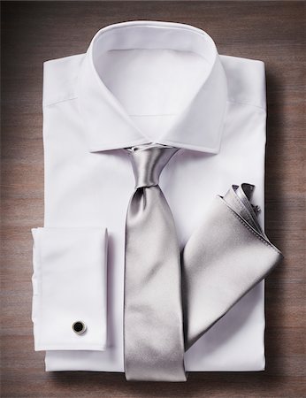 White shirt with a tie, handkerchief and cuff link, studio shot on wooden background Stockbilder - Premium RF Lizenzfrei, Bildnummer: 600-08353425