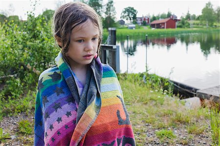 Portrait of girl standing on lakefront daydreaming and wrapped in beach towel, Sweden Photographie de stock - Premium Libres de Droits, Code: 600-08353430