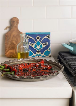 Platter of Roasted Red Peppers on Kitchen Counter with Bottle of Olive Oil Stock Photo - Premium Royalty-Free, Code: 600-08512606