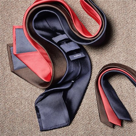 simsearch:600-08542905,k - Three coloured neckties draped on a light brown fabric Stockbilder - Premium RF Lizenzfrei, Bildnummer: 600-08542896
