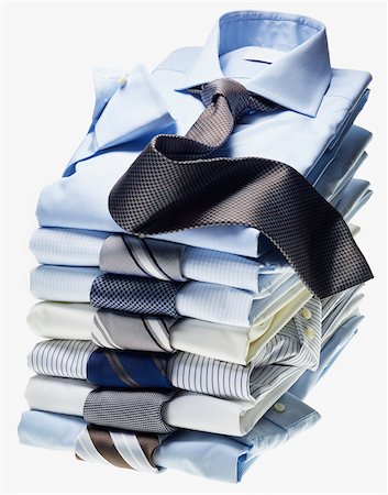 Stack of multi coloured shirts with ties on white background Stockbilder - Premium RF Lizenzfrei, Bildnummer: 600-08542891