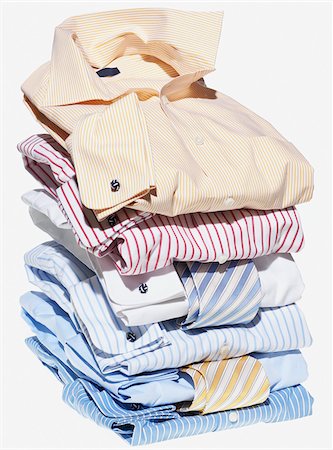 Stack of multi coloured shirts with ties on white background Stock Photo - Premium Royalty-Free, Code: 600-08542893