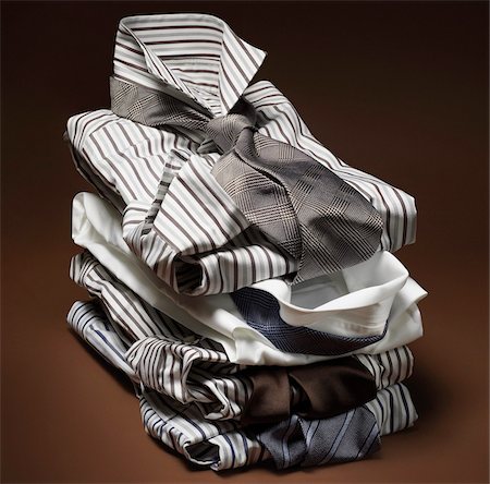 simsearch:600-00163321,k - Stack of men's, striped dress shirts with ties on brown background Photographie de stock - Premium Libres de Droits, Code: 600-08542912