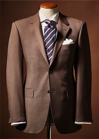 simsearch:600-08567200,k - Brown suit jacket on bust with handkerchief and tie on brown background Stock Photo - Premium Royalty-Free, Code: 600-08542913