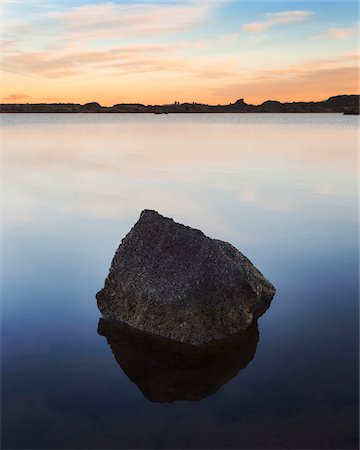 pink sky calm - Boulder in the middle of the calm waters of Myvatn Lake at sunrise, a eutrophic body of water in Northeast Iceland Stock Photo - Premium Royalty-Free, Code: 600-08765598