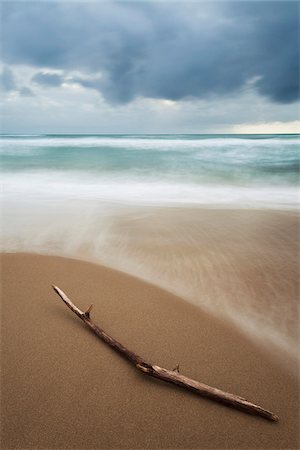 Driftwood and blurred surf crashing the sands on the beach at San Felice Circeo in the Province of Latina in Lazio, Italy Stock Photo - Premium Royalty-Free, Code: 600-08765606